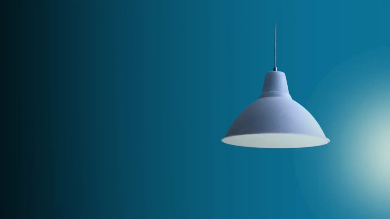 Warm desk lamp beside a workspace — ivvi customer support hero background