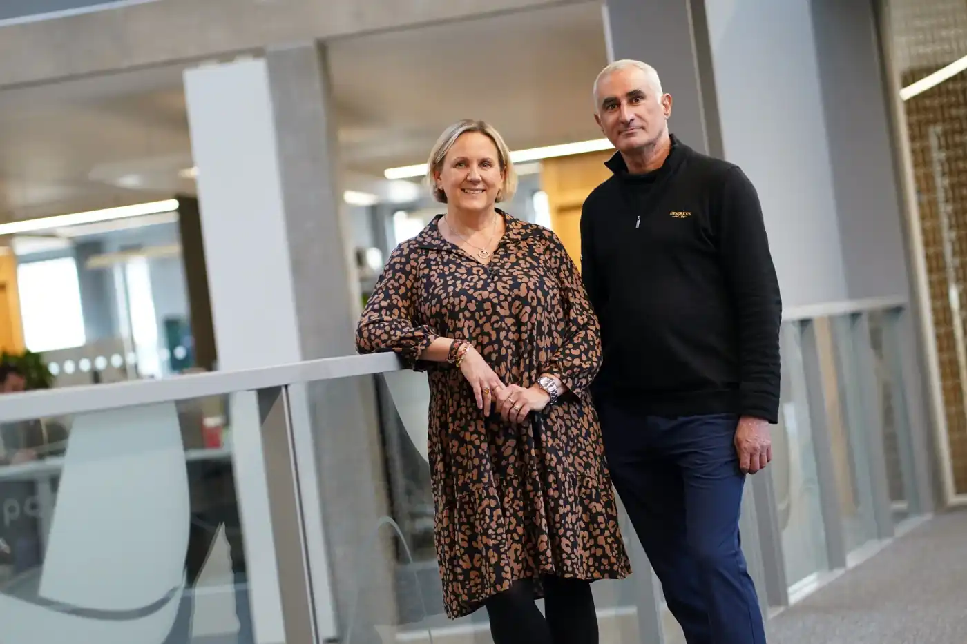 Darius and Jo standing together in office space